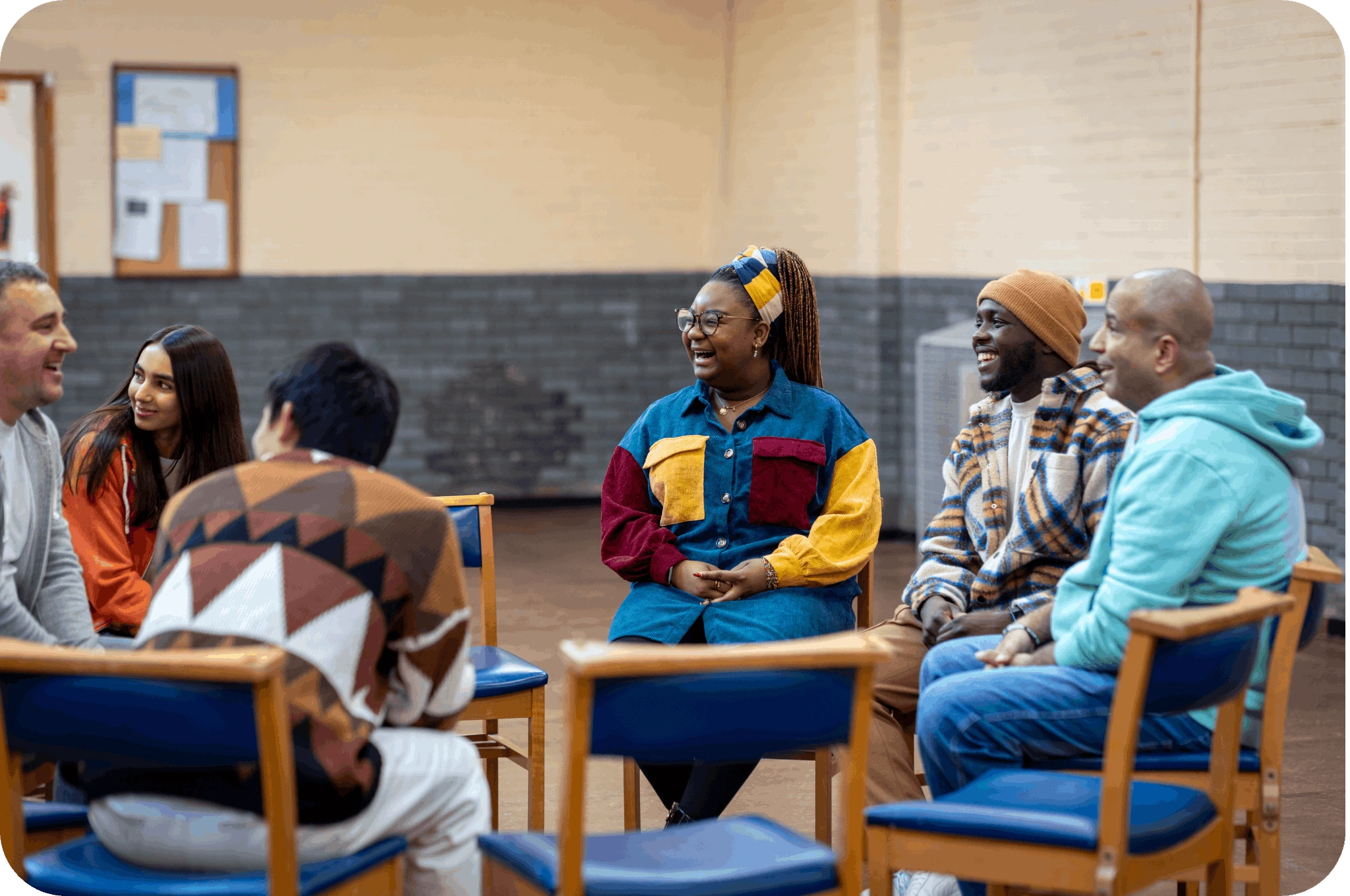 A group of people sitting in a circle, having a conversation